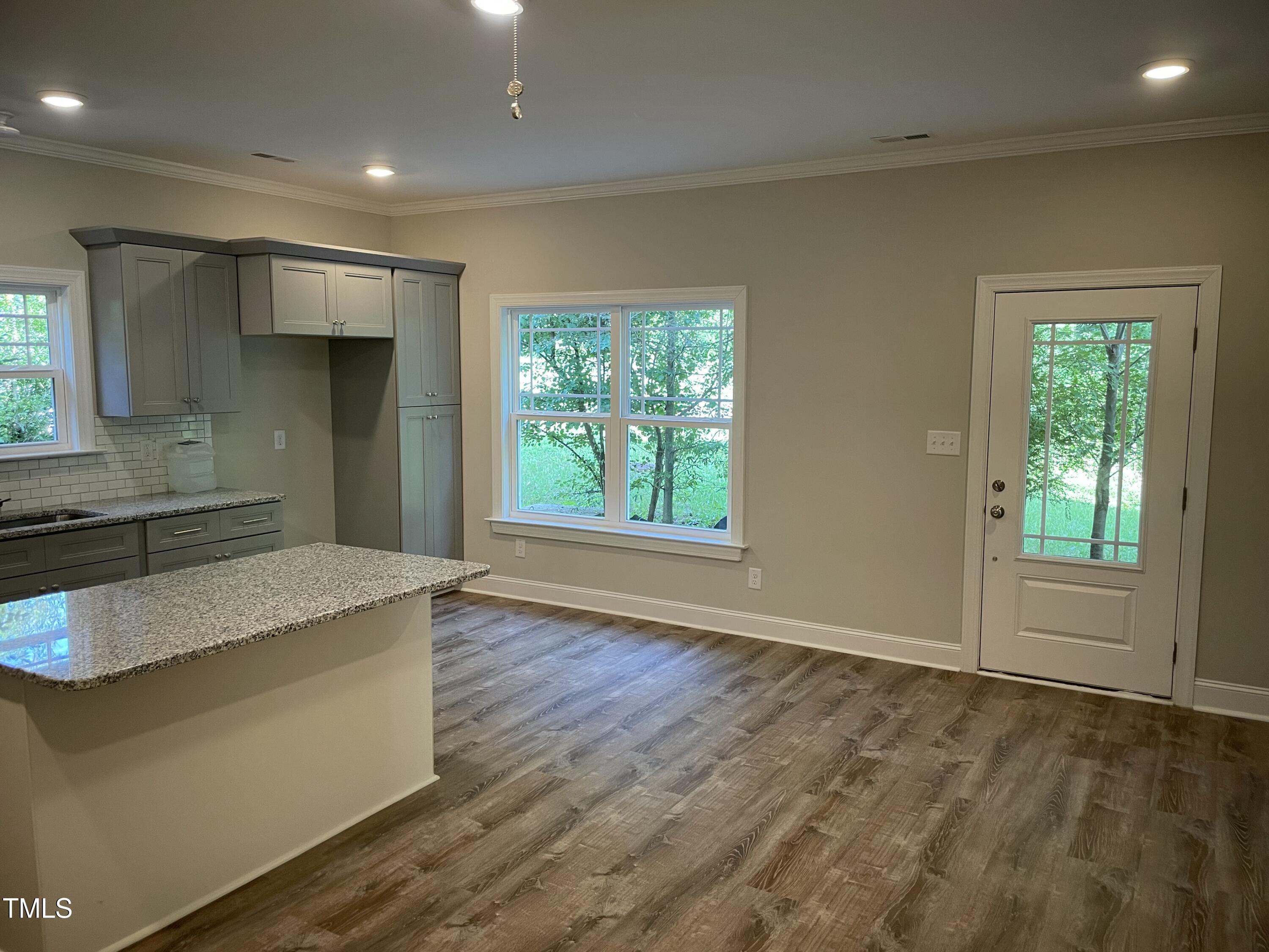5500 Batoul Lane Raleigh, NC 27606 - Photo 5 of 32 a kitchen with stainless steel appliances granite countertop a stove a sink and a refrigerator