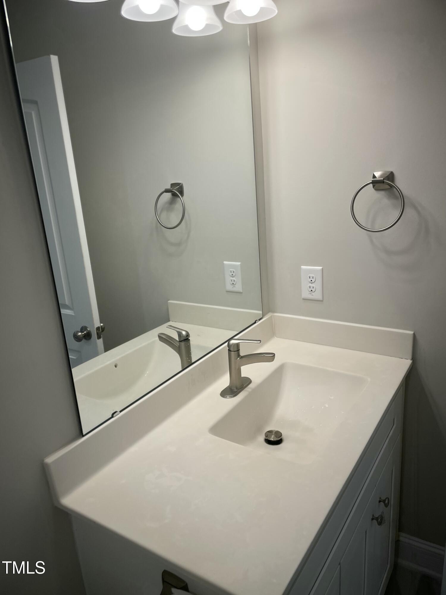 5500 Batoul Lane Raleigh, NC 27606 - Photo 10 of 32 a bathroom with a sink and mirror