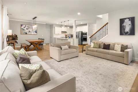 a living room with furniture and a view of kitchen