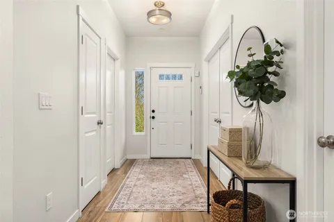 a view of an entryway with wooden floor