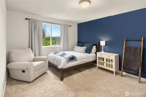 a bedroom with a bed and a couch