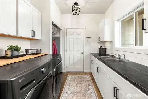 a kitchen with stainless steel appliances a sink stove and cabinets