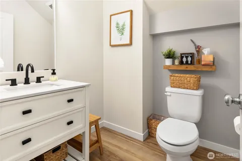 a bathroom with a toilet a sink and mirror
