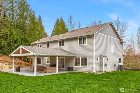 a view of a house with a yard and sitting area
