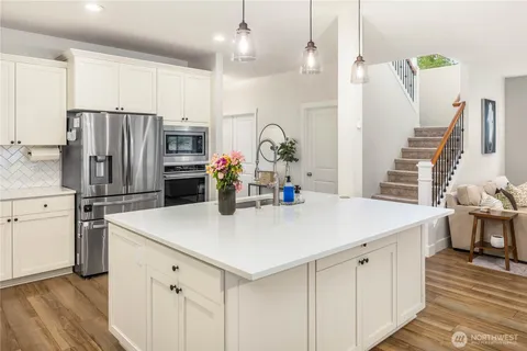 a kitchen with stainless steel appliances a sink stove and refrigerator