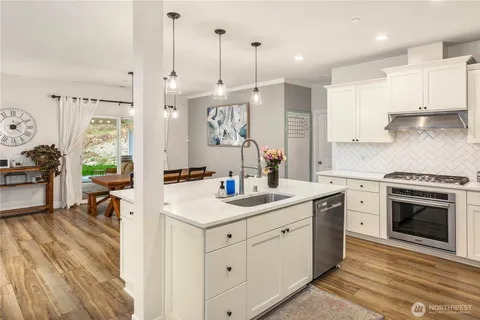 a kitchen with a sink stove and cabinets