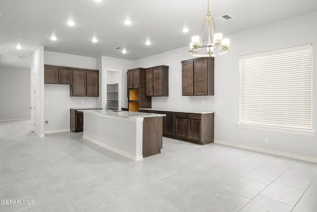 a large kitchen with kitchen island a sink stainless steel appliances and cabinets