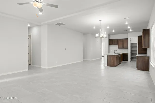 a view of a kitchen with a sink and an cabinet in an empty room