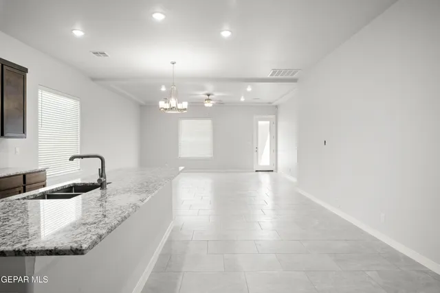 a bathroom with a granite countertop sink a vanity and mirror