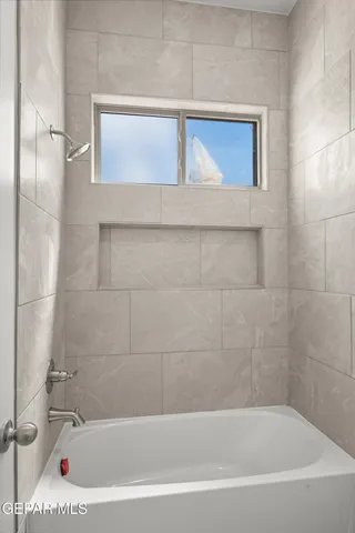 a bathroom with a bathtub and shower