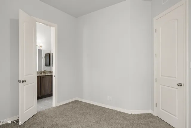 an empty room with an entryway and wooden floor