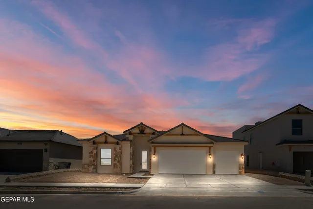 a front view of a house with a garden and yard