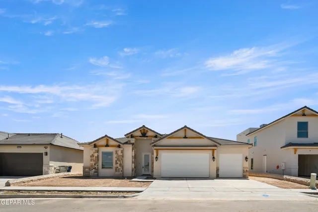 a front view of a house with a garden and pathway