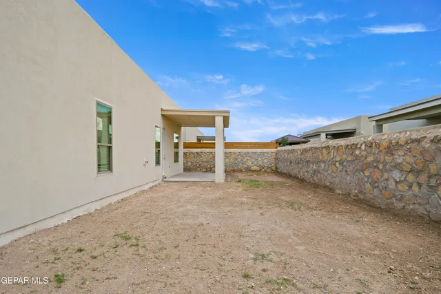 a view of a backyard with wooden fence