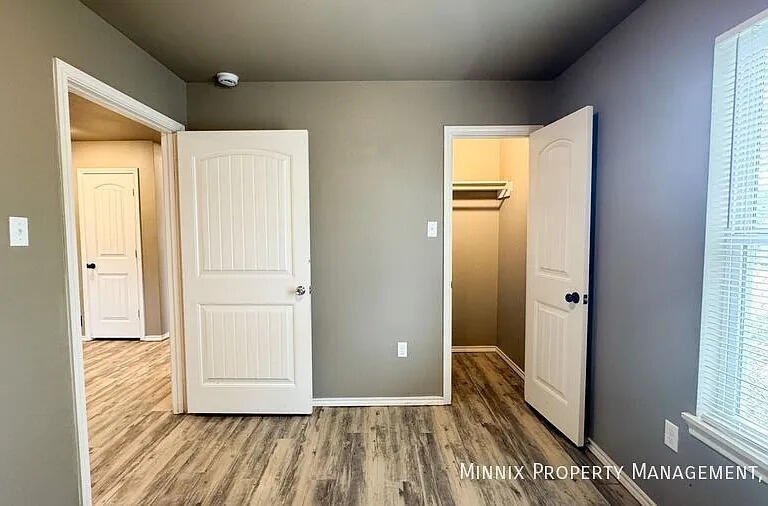 517 44th Street Lubbock, TX 79404 - Photo 8 of 10 a view of a hallway with wooden floor and a bathroom