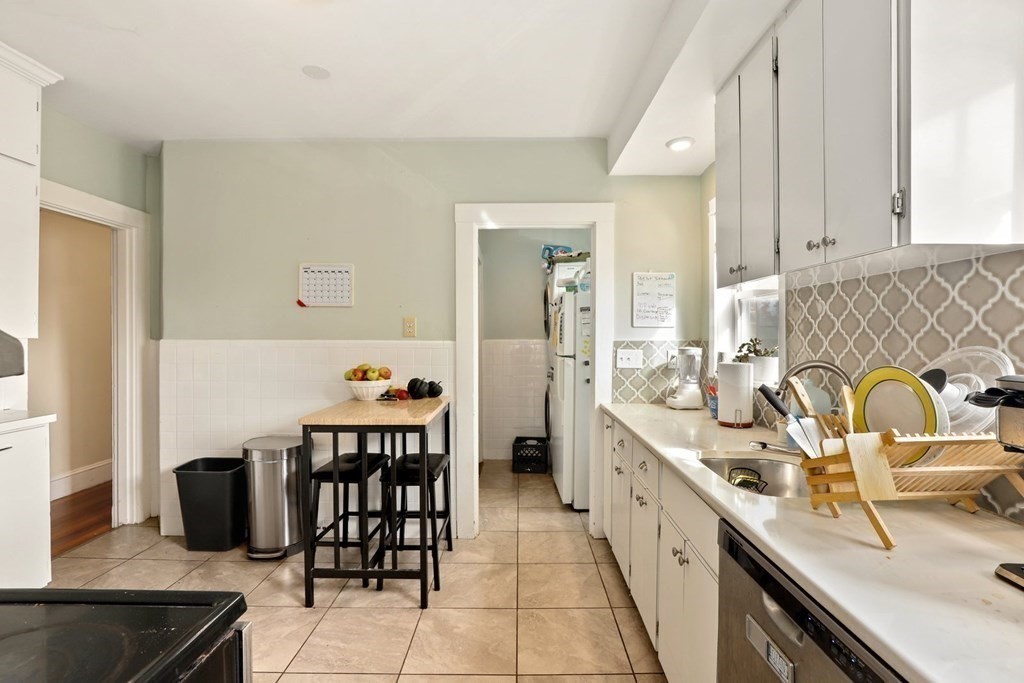 3 Clark Road Brookline, MA 02445 - Photo 7 of 24 a large white kitchen with a stove a sink and a refrigerator