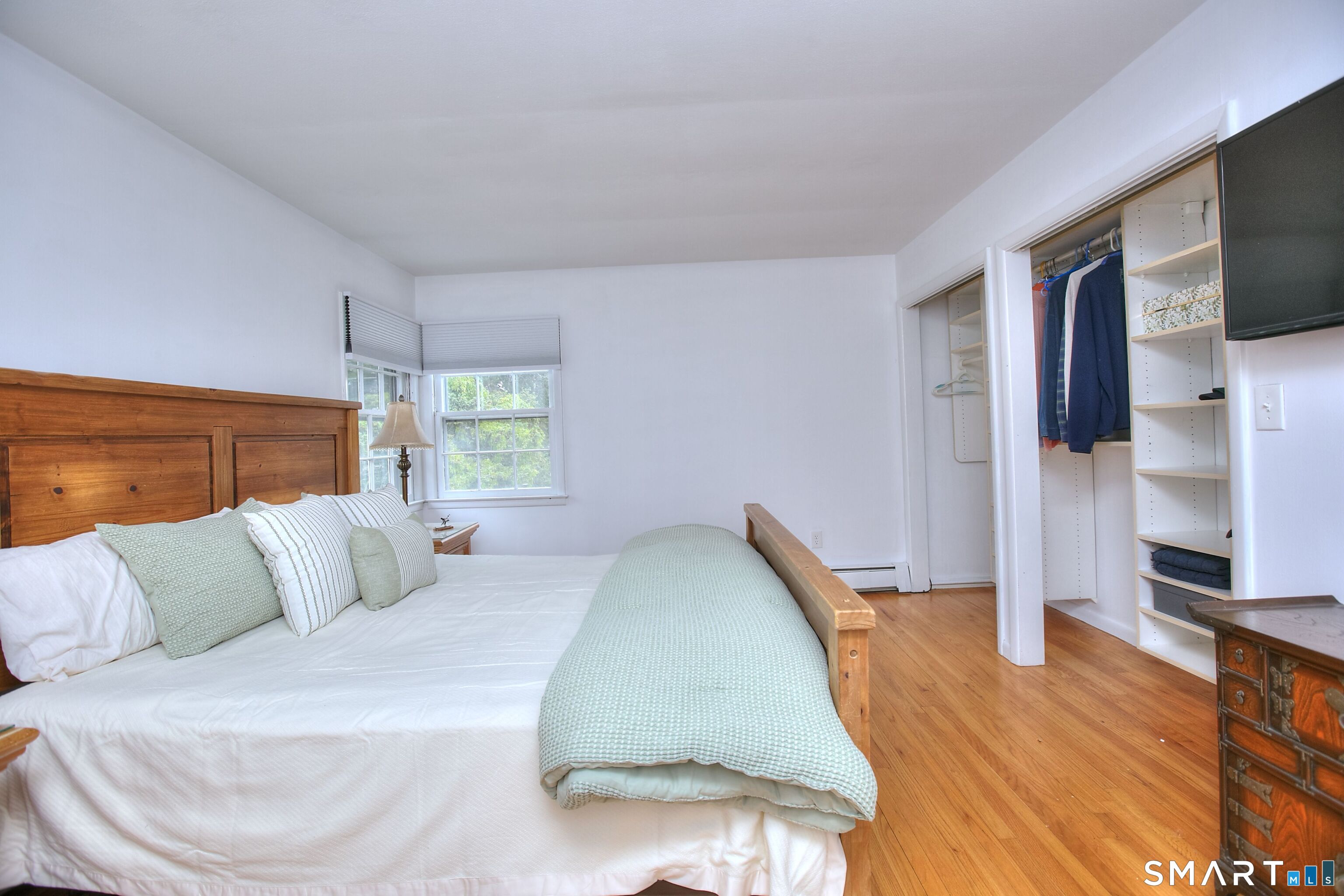 324 Ridge Road Orange, CT 06477 - Photo 25 of 38 a bedroom with a bed and a flat screen tv