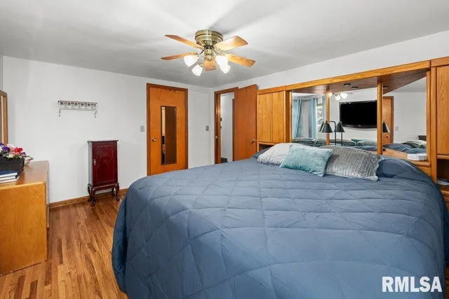 a bedroom with a large bed and a flat screen tv