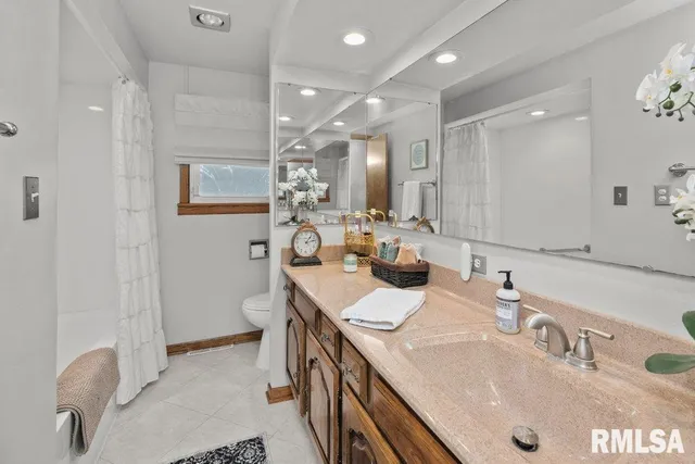 a bathroom with a sink double vanity granite and a mirror