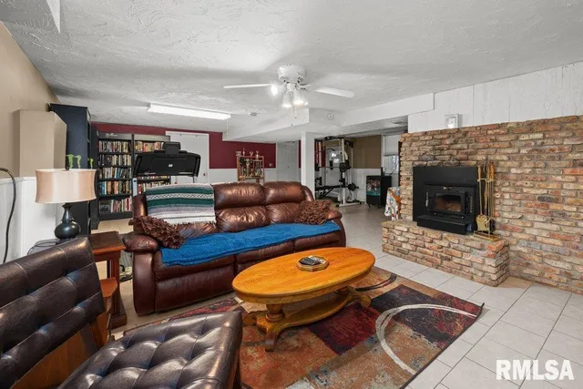 a living room with furniture a flat screen tv and kitchen view