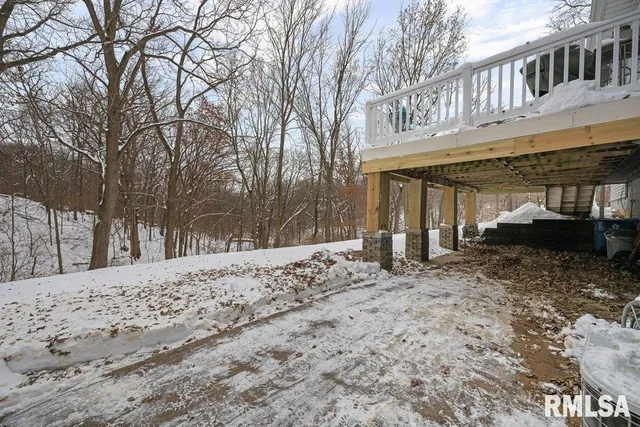 a view of a house with a yard covered in snow