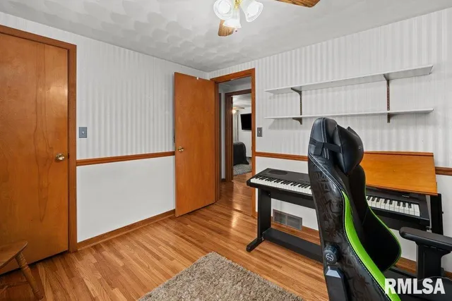 a view of a livingroom with furniture and a workspace