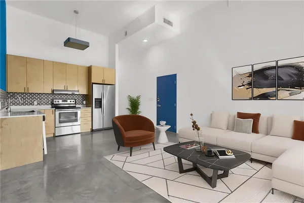 a living room with furniture and a wooden floor