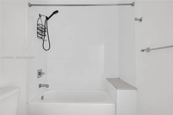 a bathroom with a bath tub with a shower