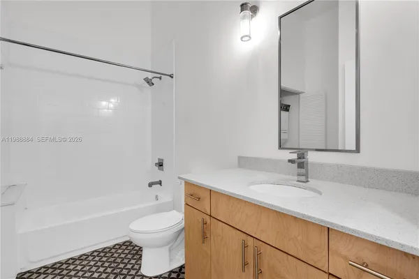 a bathroom with a sink a toilet and a bathtub