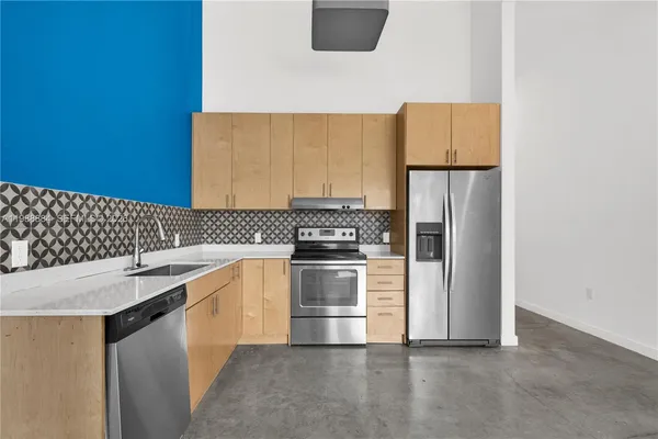 a kitchen with a sink stove and refrigerator