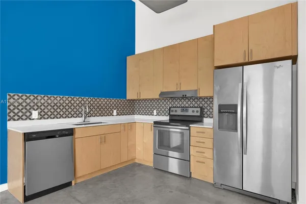 a kitchen with a refrigerator and cabinets