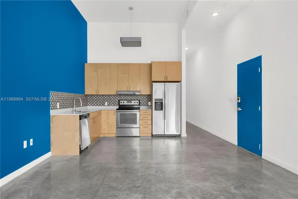 a view of kitchen with stainless steel appliances cabinets and stove
