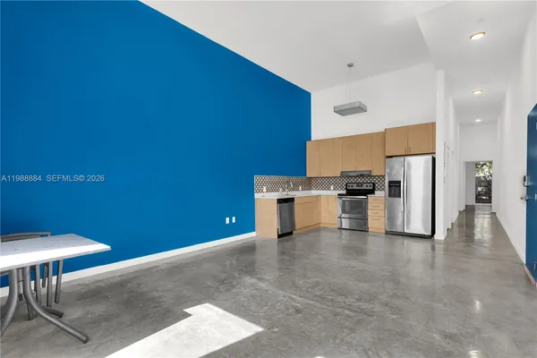 a kitchen with stainless steel appliances kitchen island granite countertop a stove a refrigerator and a microwave