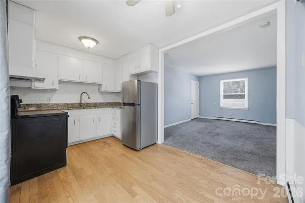 a kitchen with a refrigerator sink and cabinets
