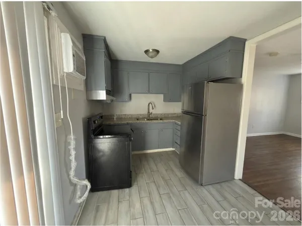 a kitchen with a sink stainless steel appliances and cabinets