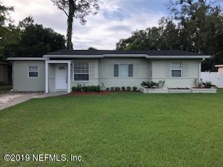 2002 Clemson Road Jacksonville, FL 32217 - Photo 1 of 15 a front view of a house with a garden and yard