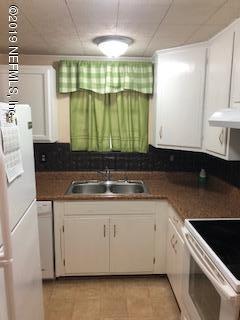 2002 Clemson Road Jacksonville, FL 32217 - Photo 12 of 15 a kitchen with granite countertop a sink a stove and cabinets
