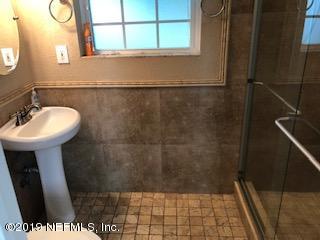 2002 Clemson Road Jacksonville, FL 32217 - Photo 9 of 15 a bathroom with a sink a mirror and a shower