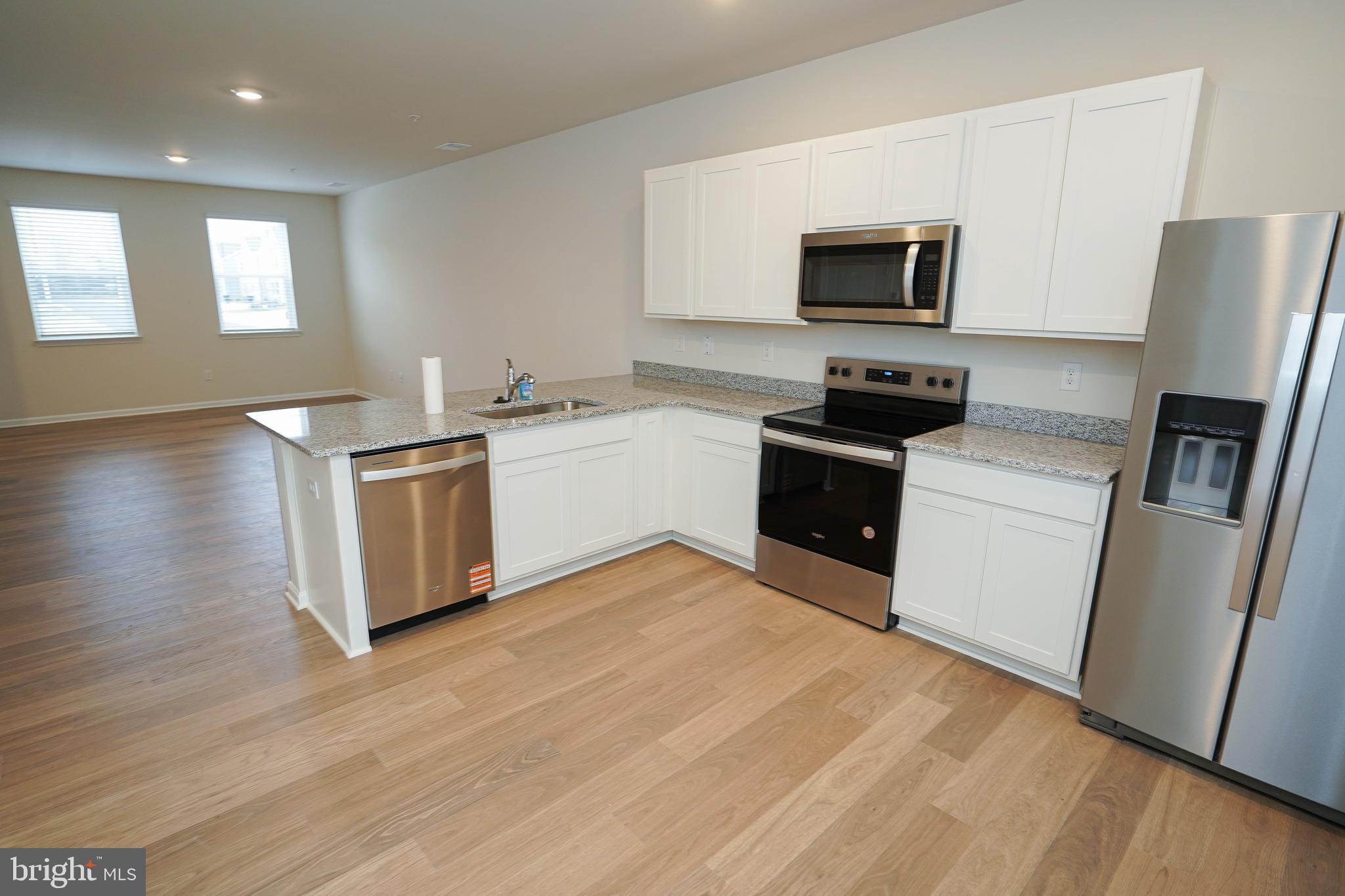 852 Mersey Lane Salisbury, MD 21801 - Photo 14 of 40 a kitchen with stainless steel appliances granite countertop a stove top oven a sink dishwasher a refrigerator and a microwave