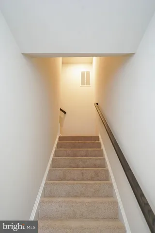 a view of a hallway with wooden floor and closet