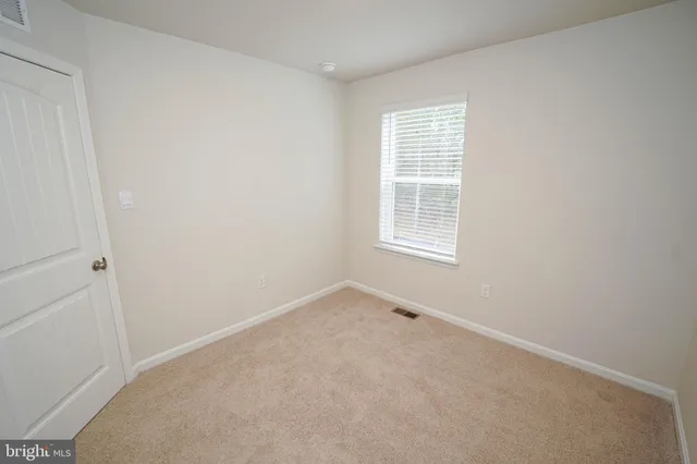 an empty room with closet area