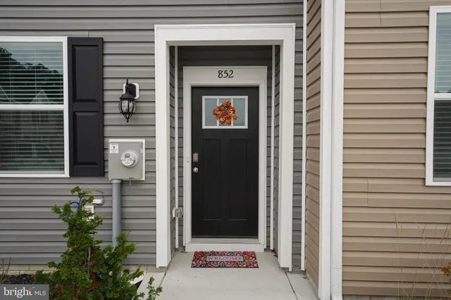 a view of a door and brick walls
