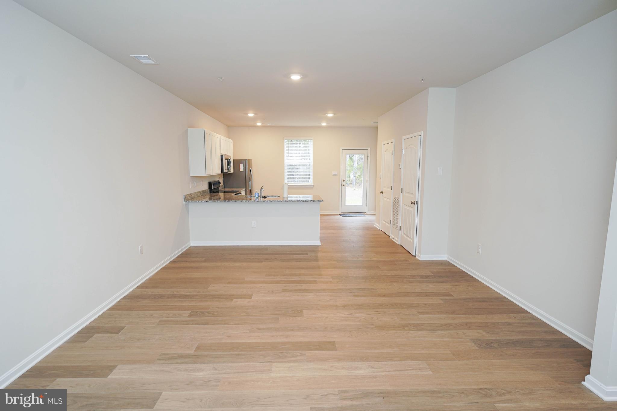 852 Mersey Lane Salisbury, MD 21801 - Photo 8 of 40 a view of a kitchen with wooden floor and a sink