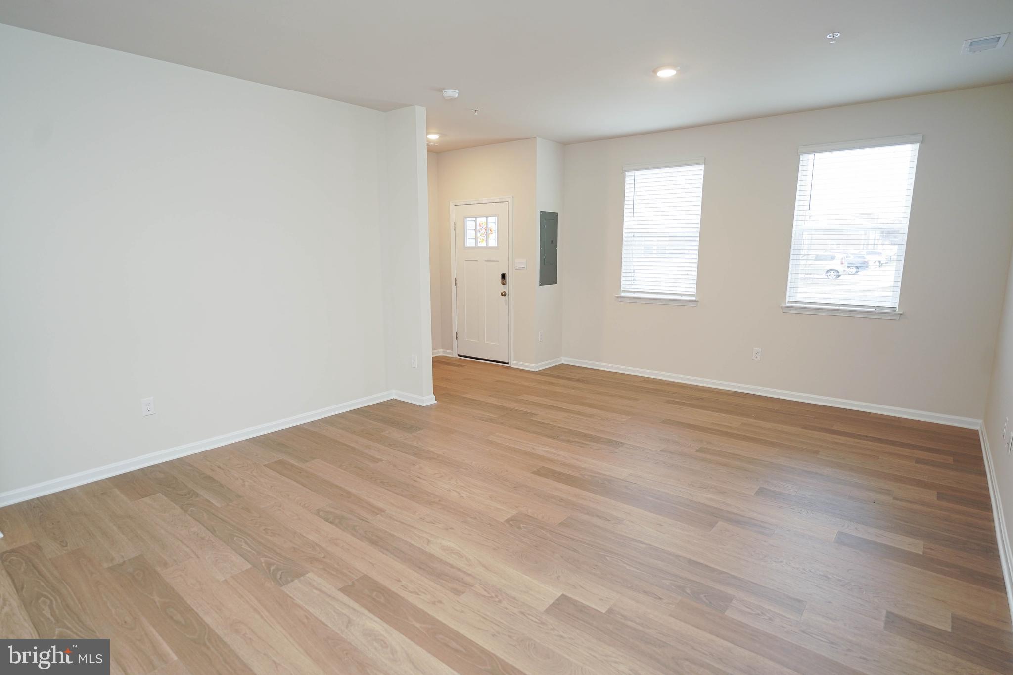 852 Mersey Lane Salisbury, MD 21801 - Photo 10 of 40 an empty room with wooden floor and windows