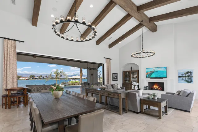 a bedroom with a large bed and a flat tv screen on dresser