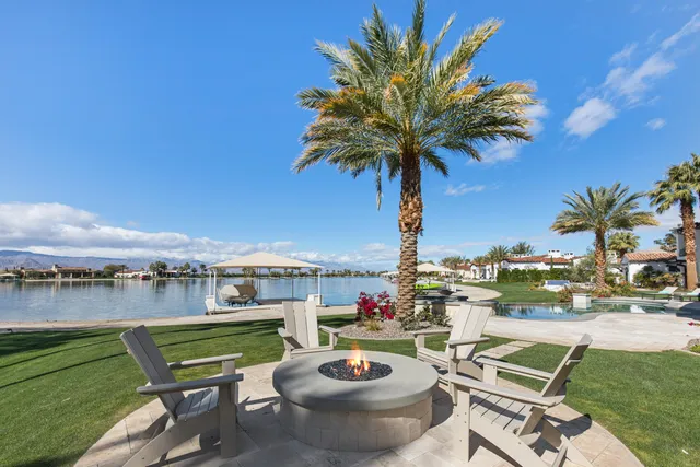 a view of a chairs and table in patio with a lake view