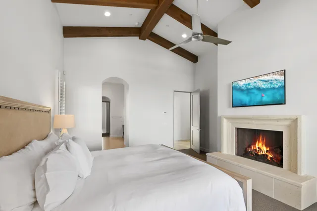 a bedroom with a bed a dresser and a mirror