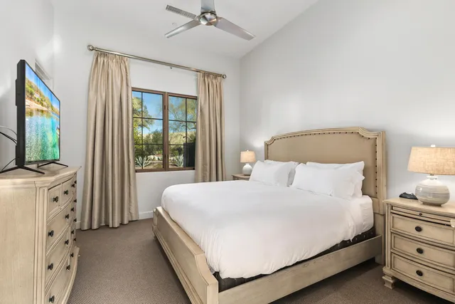 a view of a lake with couches under an umbrella