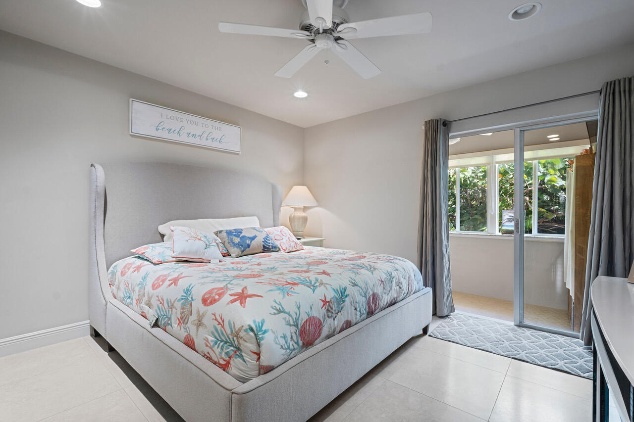 5505 North Ocean Boulevard, Unit 3203 Ocean Ridge, FL 33435 - Photo 11 of 25 a bedroom with a bed and a large mirror