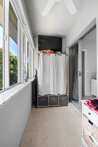 a view of a bedroom with furniture and window